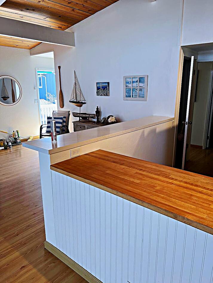 Custom wood bar top and beadboard panelling in a remodeled home