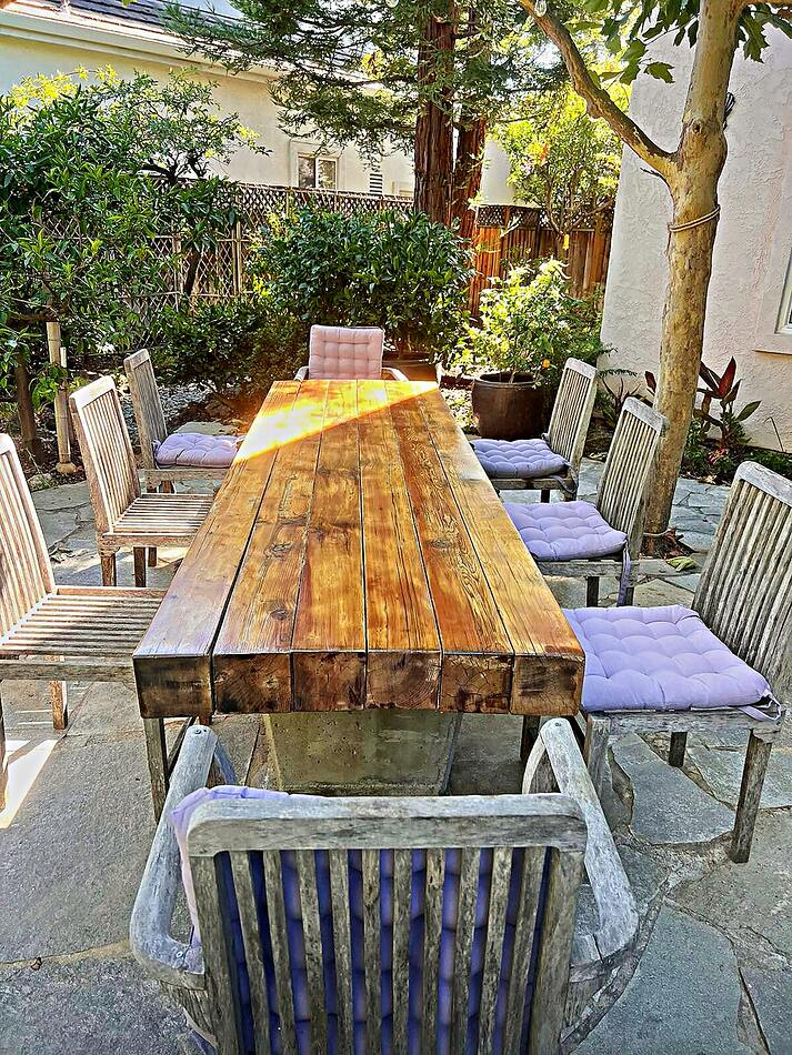 Reclaimed timber dining table rebuilt for a garden patio